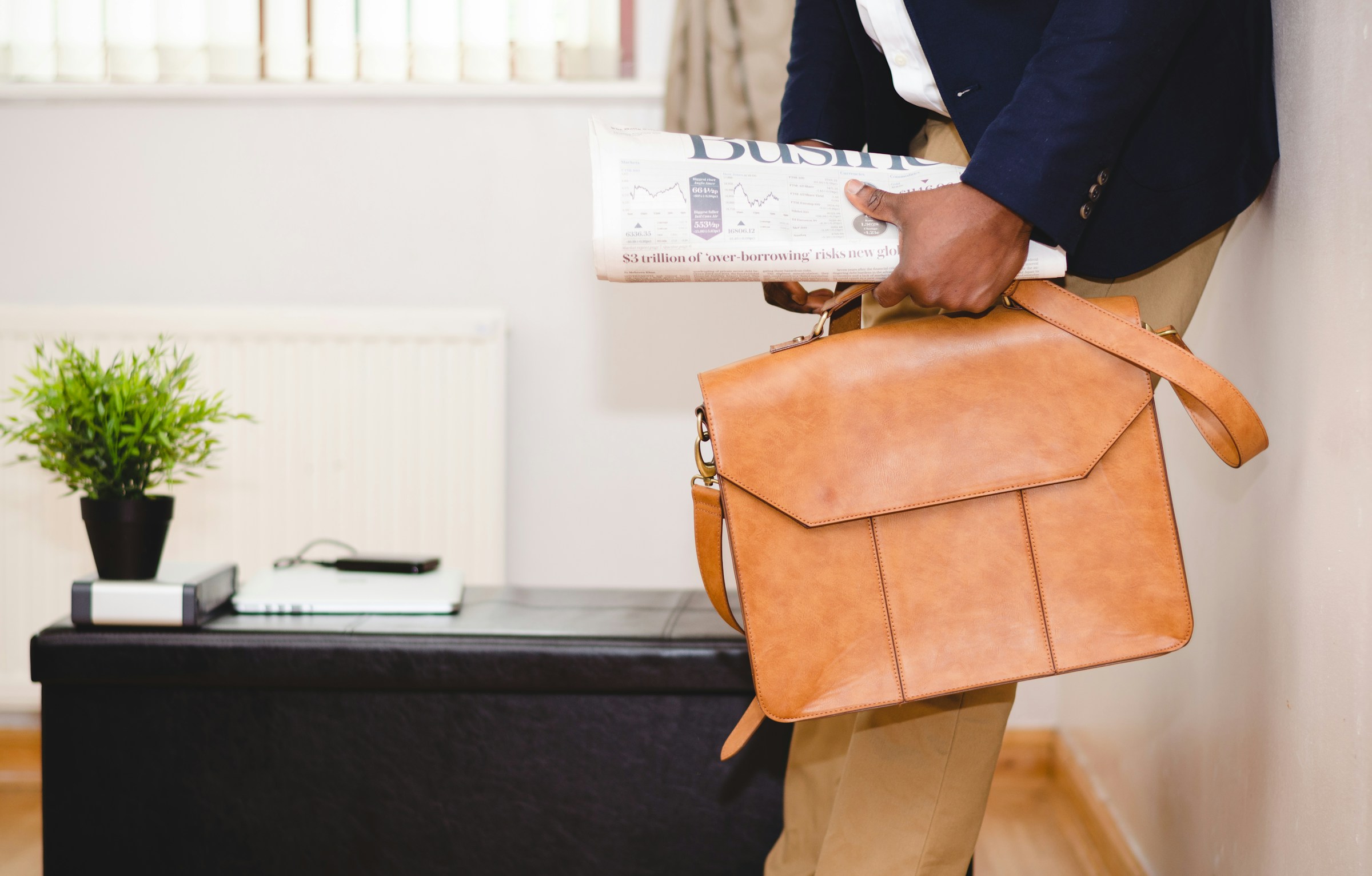 business man with newspaper and suitcase